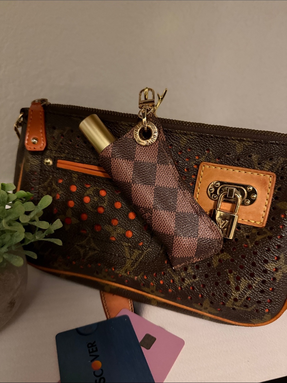 Upcycled Louis Vuitton’s Brown Checkered Key lip gloss/lighter bag charm.